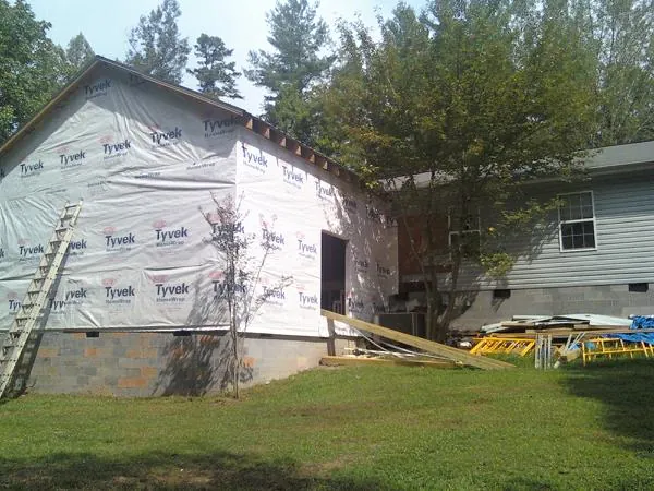 Tyvek wrapped gable on a new room addition beside an existing home in Winterthur